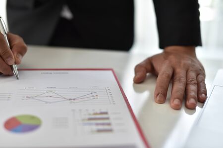 Business man hand pointing to graph information. new startup project. Idea presentation, analyze...