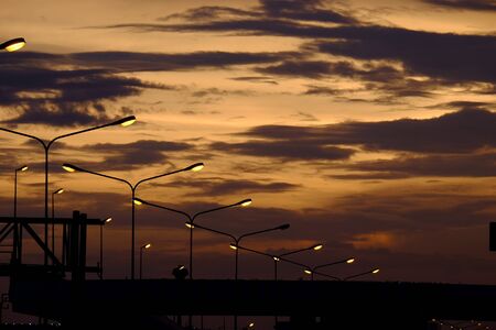Beautiful sunset above the sea.Gold Sunset, sea and clouds. Beautiful golden orange sunset over the ocean. The sun sets turning the sky yellow, orange & red tones & reflects in the ocean.の写真素材