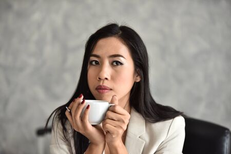 The secretary or staff or accounting officer. At her desk she was refreshing with a good work day.	Portrait of smart young successful businesswoman in suitの写真素材