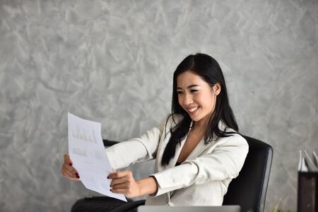 Young businesswoman expresses gladness with the news. And the success of the work.の写真素材