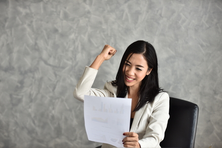 Young businesswoman expresses gladness with the news. And the success of the work.