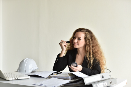 A pretty and cheerful engineer working in an office.の写真素材