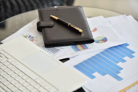 Graphs of earnings Notebook and pen Put on the meeting tableの写真素材