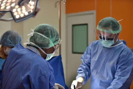 Team surgeon at work in operating room. Surgical light in the operating room. Preparation for the...
