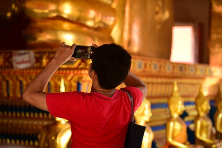 The golden Buddha image. Reverence in Buddhist sutras At Wat Luang Pothit, Thailandのeditorial素材