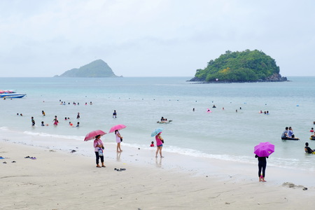The tourists are swimming at the beach. And stroll along the sandy beach. Must use the umbrella on a rainy day at the beach, Sattahip, Chonburi, Thailand on April 28, 2018.のeditorial素材