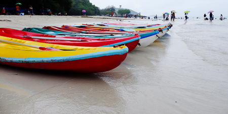 Boat at the seafront and kayak at the beach on the rainy day.の写真素材
