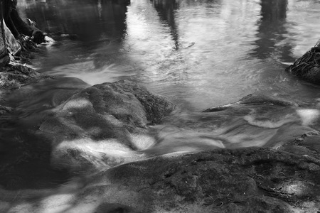 A calm river flowing among the rocks in the rainforest in Karnchanaburi Province Thailandの写真素材