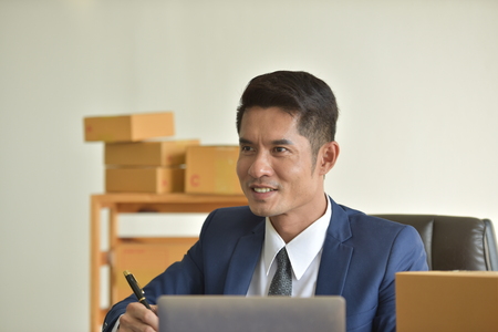 Delivery Business And online delivery services. Business Start up SME concept. Young startup entrepreneur small business owner working at home, packaging and delivery situation.の写真素材