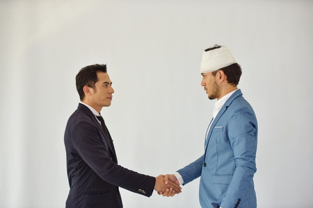 Business Collaboration. Concept of reliability of partnership and cooperation. business. Good deal. Close up of two business people shaking hands while sitting at the working place.の写真素材