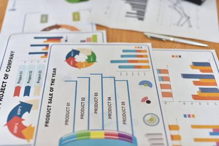 The paper reports the results of business operations. Close up of business documents on the table. Business man with a chart, Business vision.の写真素材