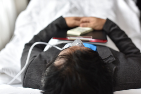 Businessmen are also working and making money while they sleep in bed in the hospital. Business Conceptsの写真素材