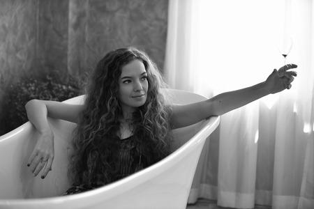 young woman laying in bathtub.relaxed time in bathroom.young woman relaxing in bathtub.