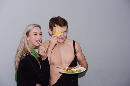 Couples are eating together. And the love close. Show love at the restaurant at leisure. Portrait of a bright couple enjoying a meal. And enjoy drinks.の写真素材