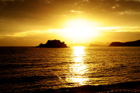 Sunset at the beautiful beach view Among the many people come to play in the sea before the dusk.silhouette of sunset at beach.の写真素材