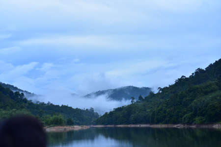 Landscape of mountain and river with fog in the morning, Thailandの写真素材