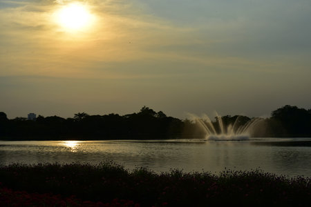 Fountain on the lake at sunset, beautiful landscape in Thailand.の写真素材