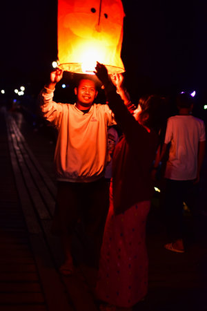 Unidentified Thai people light up the lamp during Loy Krathong festival in Chiang Mai, Thailand.の写真素材