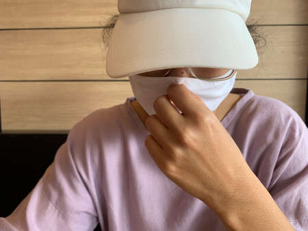 Woman afraid of infection Be careful by wearing a hygiene maskの写真素材