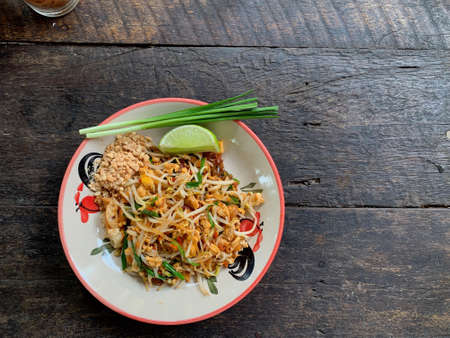 Pad thai or fried noodle thai style on wood tableの写真素材
