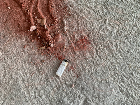 Cigarette on the cement floor.
