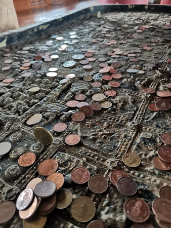 Thai Baht coins on the floor in temple, Thailand.