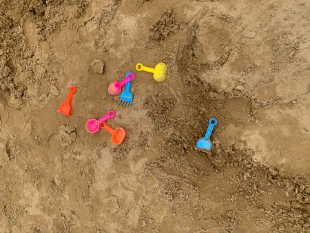 Colorful children's toys on the ground in the sandbox. Top view.の写真素材