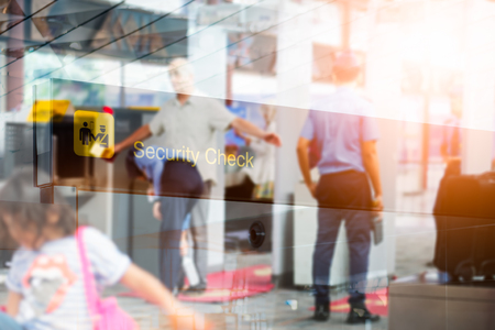 Double exposure of  security check airport sign ,Airport security check at gates with metal detector and scannerの写真素材