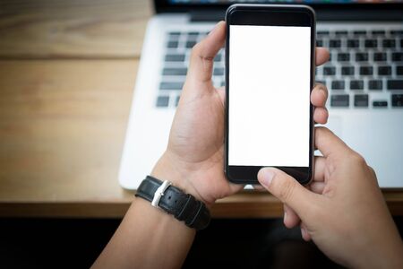 Cropped shot view of woman's hands holding smart phone with blank copy space screen for your text...