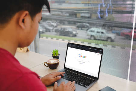Bangkok. Thailand. APR 24,2021 :A man is typing on Google search engine from a laptop. Google is the biggest Internet search engine in the world.のeditorial素材
