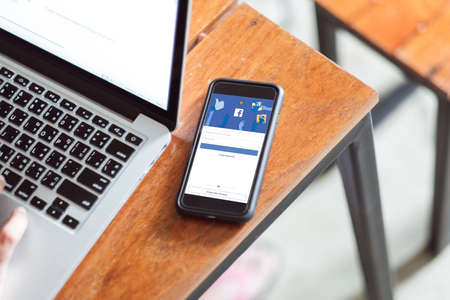 Bangkok. Thailand. JAN 6,2021: Facebook social media app logo on log-in, sign-up registration page on mobile app screen on iPhone smart devices in business person's hand at workのeditorial素材