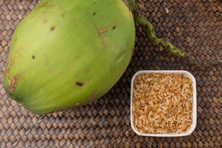 Roasted coconut in white cup and coconut on the tray, Natural light beautiful.の写真素材