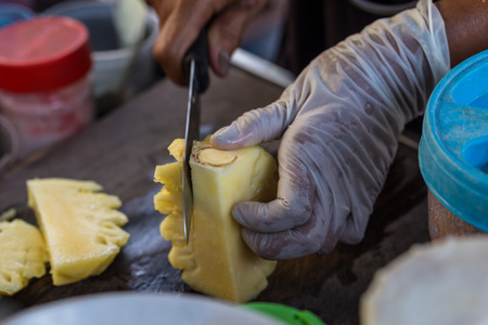 Close up Fruit traders are cutting pineapple for sale. Street Food in Thailand.の写真素材