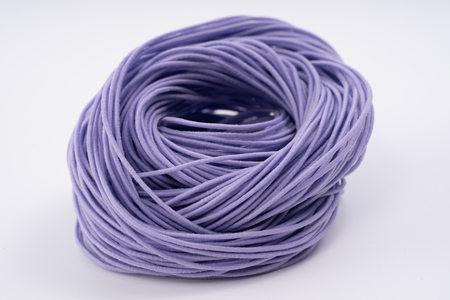 Rope, purple rubber rope. Twisted rope beautifully on a white background.の写真素材