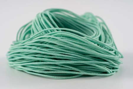 Rope, green rubber rope. Twisted rope beautifully on a white background.の写真素材