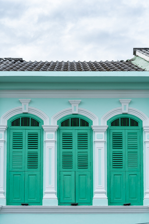Bright vintage Sino-Portuguese Architecture of many the buildings in Phuket town. These old buildings have been constructed more than hundred years and this architectural style is European mixed with Chinese modern. Phuket, Thailand. Ancient window.の写真素材