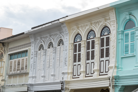 Bright vintage Sino-Portuguese Architecture of many the buildings in Phuket town. These old buildings have been constructed more than hundred years and this architectural style is European mixed with Chinese modern. Phuket, Thailand. Ancient window.の写真素材