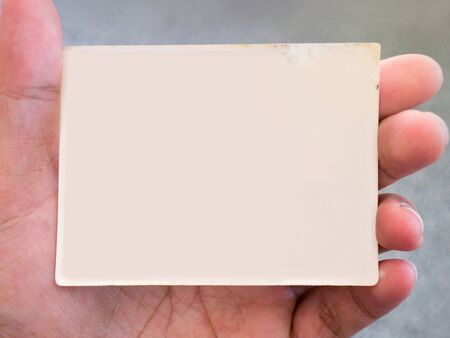 old white picture frame background on a man hand.