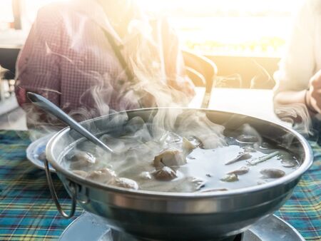Tom Yum hot and sour soup mixed clear water In the hot pot. Food smoke floating around. Delicious food Of Thailand.の写真素材