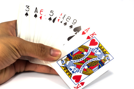 Playing cards in hand isolated on white background