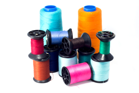 Colorful bobbins of thread isolated on white