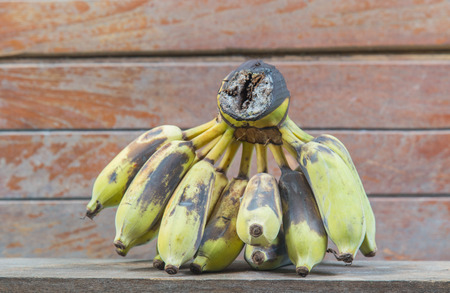 old bananas on wooden shelf , blured wood background.の写真素材