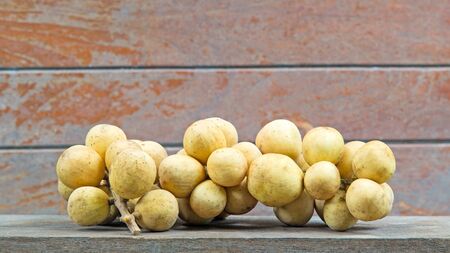 fresh fruit longkong on the wood backgroundの写真素材