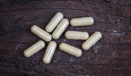many capsule pill on wooden backgroundの写真素材