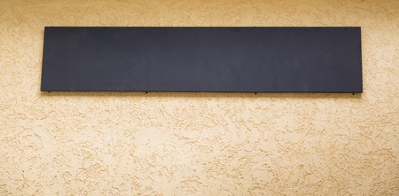 Blank black billboard with copy space for your text message or promotional content, public information board on the street, advertising mock up empty banner, clear poster.の写真素材