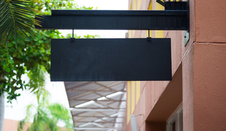 Blank black billboard with copy space for your text message or promotional content, public information board on the street, advertising mock up empty banner, clear poster.の写真素材