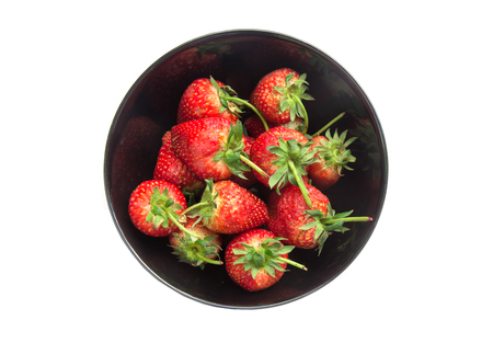 Strawberry in a bowl isolated on white background.の写真素材