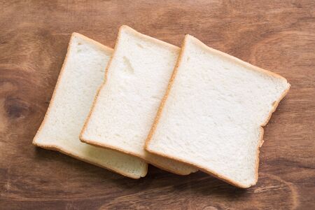Sliced bread on wooden background.の写真素材