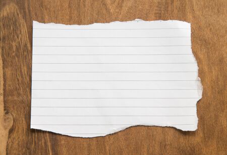 Blank torn paper on wooden background.の写真素材