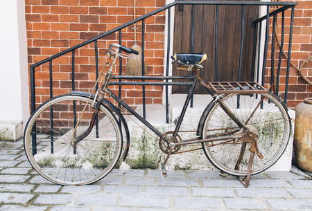 Vintage concept - retro bicycle leaning against old building.の写真素材